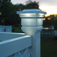 Picture of a solar post cap light mounted on a deck post.