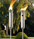 Picture of two stainless steel tiki torches.